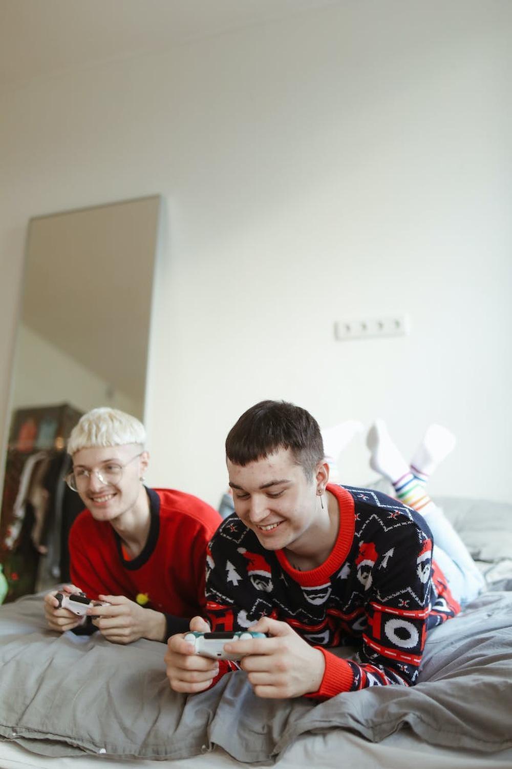 a_couple_playing_video_games_on_the_bed